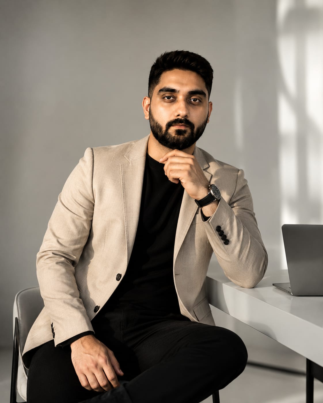 Dhruv Ohri seated in a light blazer